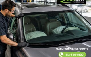 Technician inspecting a vehicle windshield to ensure proper installation and maximum safety. Auto Glass Professionals